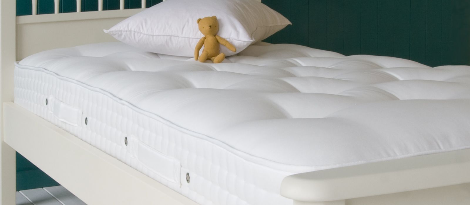 Children's mattress styled with neutral linens